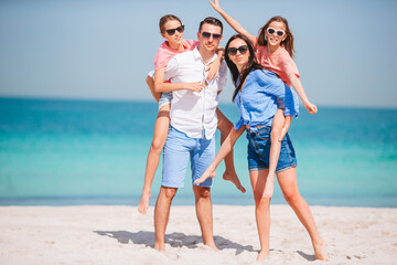 Happy family on the beach during summer vacation