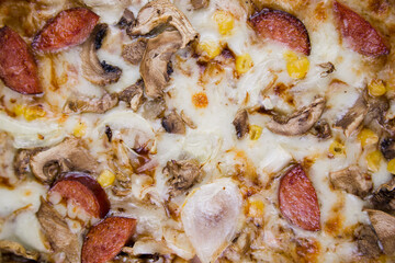 pizza with sausages and mushrooms close-up cheese