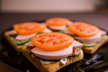delicious sandwiches with tomato and sausage on a plate