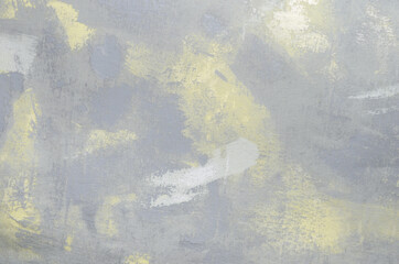 Abstract textured gray-yellow background on a cloth base.