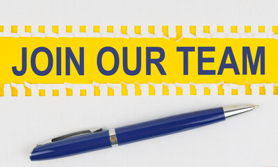 On the table are two sheets from a notebook and a pen on a yellow background written - JOIN OUR TEAM