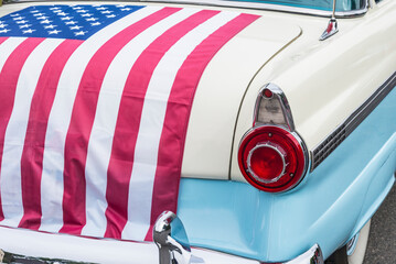 USA, Massachusetts, Essex. Antique cars, detail of 1950's-era Ford draped with US flag