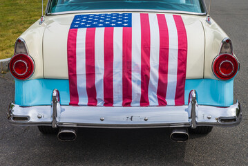 USA, Massachusetts, Essex. Antique cars, detail of 1950's-era Ford draped with US flag