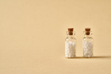 Two bottles of homeopathic remedies, with copy space