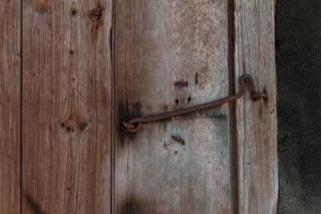 Old wooden door closed with cramps.
