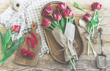 Top view bouquet of red tulips on kitchen table.
