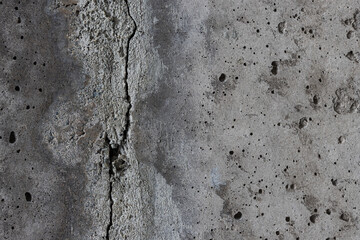 Texture of old cracked concrete wall. Rough gray concrete surface. The gap between the reinforced concrete slabs. Perfect for background and design. Close-up. High resolution.