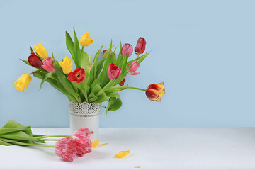 Holiday concept with flowers, spring or summer composition, still life with tulips in a vase, banner. Greeting card for mothers day, womens day, lovers day, happy birthday, wedding, selective focus,