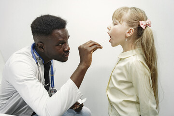 Doctor in a white uniform. Man with stethoscope. Girl with long hair.