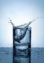 Splash of water in a glass. Splashing water. Ice water. Concept. High quality photo