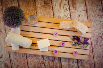 Fototapeta na wymiar Beautiful spa composition with natural soaps with scented candles and bathroom accessories in a romantic setting for a cleansing concept. There is shallow depth of field and room for text.