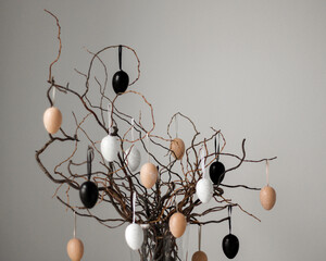 Colored easter eggs on tree branches in vase