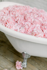 white bathroom with pink hydrangea flowers