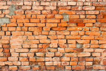 Fototapeta premium Texture of brick wall. Samples of wall or fence are presented at exhibitions. Orange brick close up.