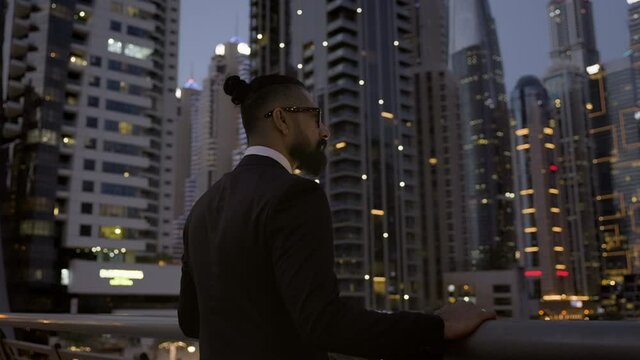Image Of Young Stylish Man In Suit. He Admires The Lights Of The Night Dubai.
