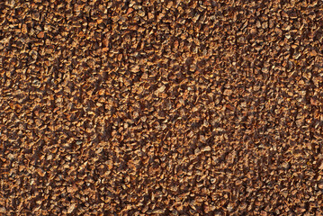 The texture of the wall is made of small yellow, black and white stones.