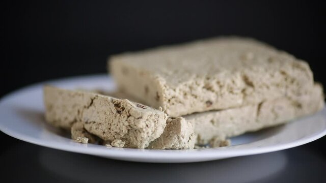 piece of sweet halva on black background