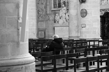 person sitting on a bench in the chuch