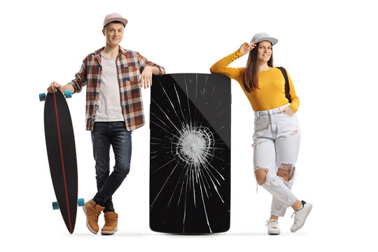 Teenagers leaning on a phone with a broken screen