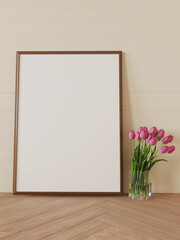 Empty picture frame mockup on wooden floor. Glass vase with tulips.