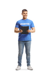 Full length portrait of a young man volunteer holding a clipboard