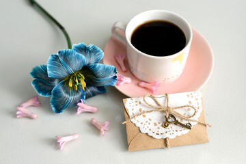 Morning coffee and blue flower on soft blue background. Concept of valentines day, birthday, easter, holiday, mothers day