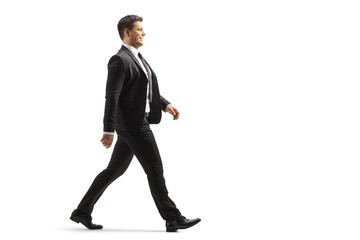 Full length profile shot of a businessman walking