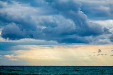 Naklejka na ściany i meble rain and large dark clouds over the sea, variety of shades of blue