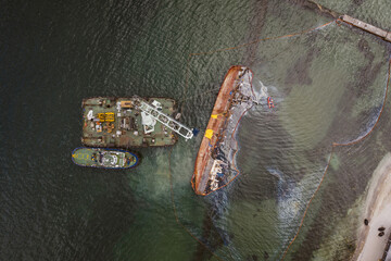 Top view of an old tanker that ran aground and overturned