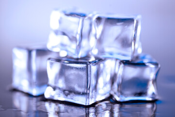Ice cubes on a blue background. Ice on a blue background