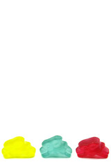 Obraz premium Colourful gummy bunnies candies isolated on white background. Fun candy macro shot. Copy space for your text.