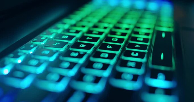 Close up of professional gaming keyboard with colorful LED backlight in multiple colors. Technology in gaming or developer industry. Desktop computer accessories for streaming work process