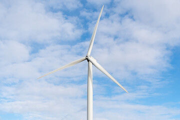 Fototapeta premium Renewable energy wind turbine in a field