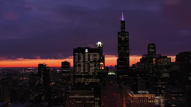 Urban Chicago Loop in Blue Hour in Winter. Evening Twilight. Aerial View. United States of America. Drone Flies Sideways. Medium Shot
