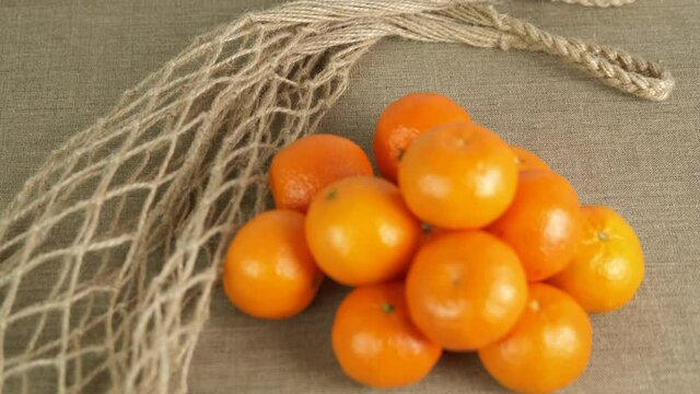 Net shopper with oranges. Tangerines with eco string bag.