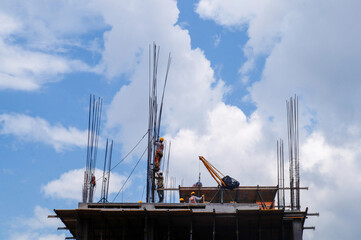 Fototapeta premium Workers on the top of a building under construction