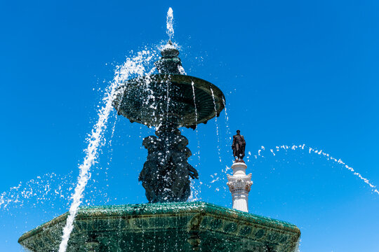 Portugal, Lisbon, Rossio, Fountain on Praca Dom Pedro IV with Column of Pedro IV in background