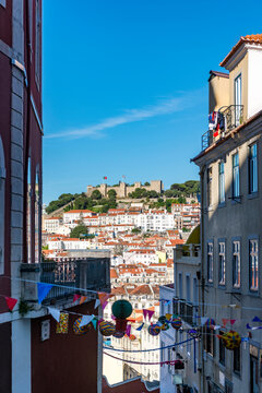 Portugal, Lisbon, Old town buildings with So Jorge Castle in distance