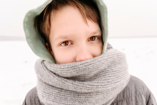 Close-up portrait of boy wearing scarf during winter