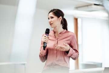 Confident businesswoman giving presentation at office