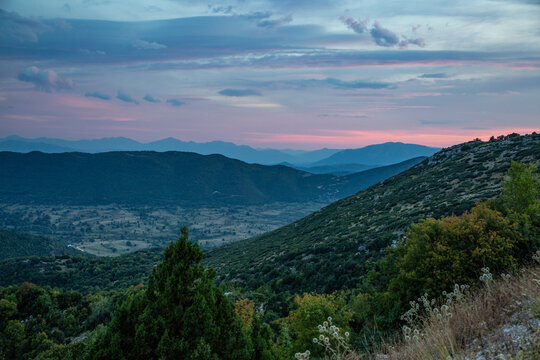 Greece, Epirus, Zagori, Pindos Mountains, Vikos National Park, View of mountains, valley and scenic sunset