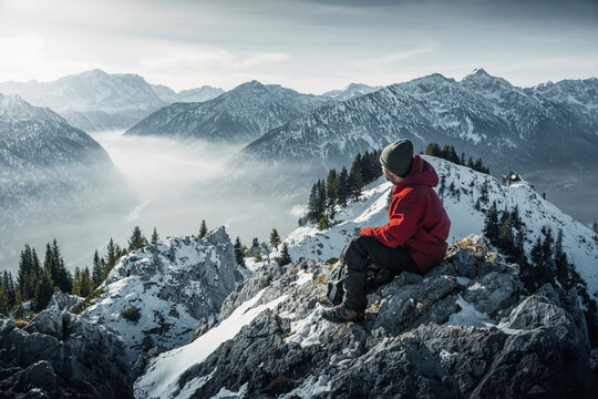 Germany, Bavaria, Ammergau Alps, Teufelstattkopf, Tourist hiking in mountains at winter day