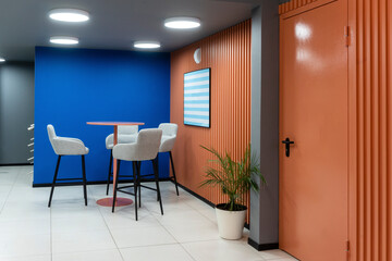 Table and chair against blue wall in office