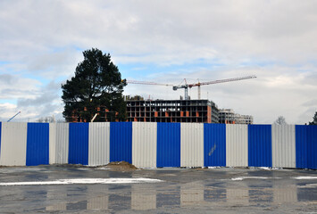 The process of building a multi-storey residential building made of red brick.
