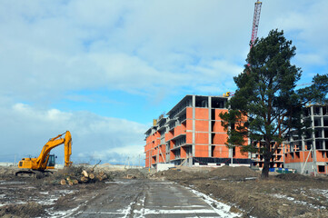 The process of building a multi-storey residential building made of red brick.