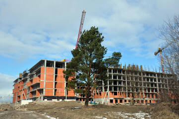 The process of building a multi-storey residential building made of red brick.