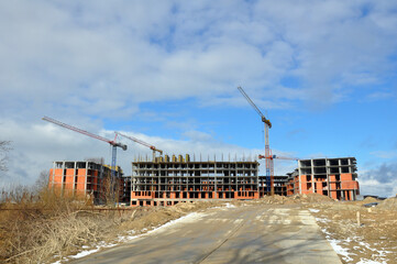 The process of building a multi-storey residential building made of red brick.