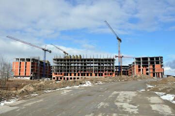 The process of building a multi-storey residential building made of red brick.