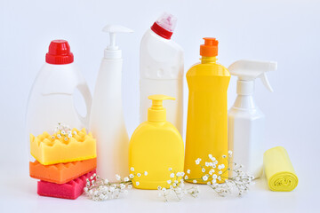 Cleaning products on white. Bottles of detergent and sponges. The concept of cleaning in the house, apartment, office. Household chemicals.