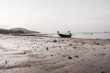 small fishing boat on the beach in the evening
